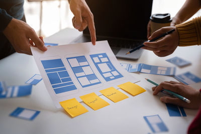 Midsection of business people working on table
