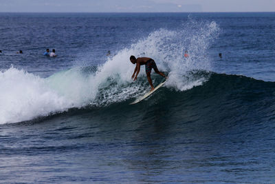 Side view of man surfing in sea