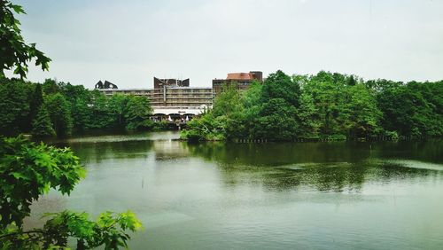 Reflection of trees and buildings in lake