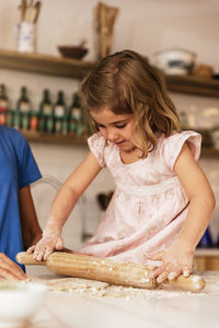 Close-up of girl preparing food at home