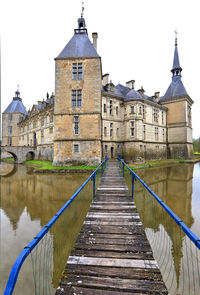 Canal amidst buildings against sky