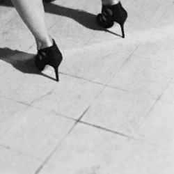 Low section of woman standing on tiled floor