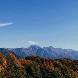 Scenic view of mountains against clear blue sky