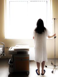 Rear view of patient standing in hospital