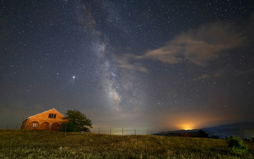 Scenic view of field against sky at night