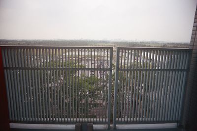 Railing by sea against sky