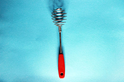 Directly above shot of pencil on table against blue background