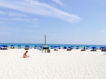 Scenic view of beach against blue sky