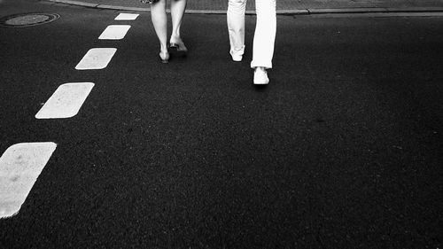 Low section of people walking on road