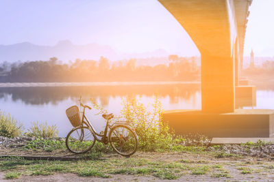 Bicycle parked under the bridge over the mekong river