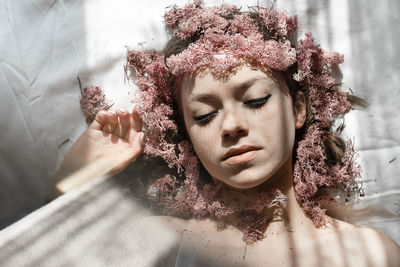 Close-up portrait of woman lying down on floor