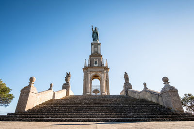 Low angle view of statue against sky