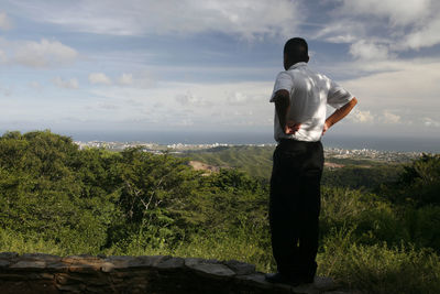 Man standing on rock looking at valley