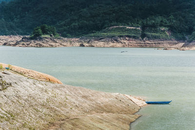 Scenic view of sea with mountain in background