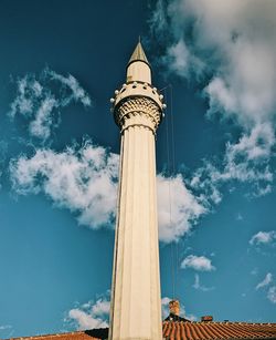 Low angle view of building against cloudy sky