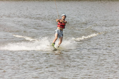 Man kite boarding in river