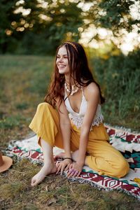 Young woman sitting on field