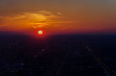 Aerial view of city against sky at sunset