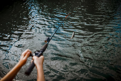 7 years old boy getting a fish on his fishing rod