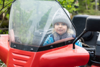 Portrait of smiling man sitting in car