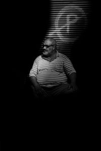 Man looking at camera over black background