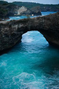 Scenic view of sea against rock formation