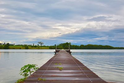 Pier over lake against sky