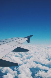 Airplane wing against blue sky