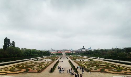 People on road against cloudy sky