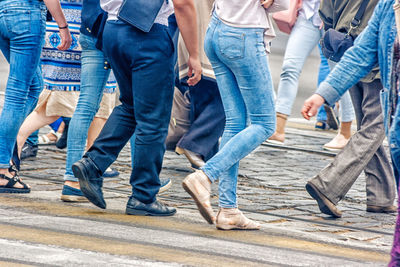 Low section of people walking on street