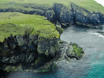 High angle view of rocks by sea