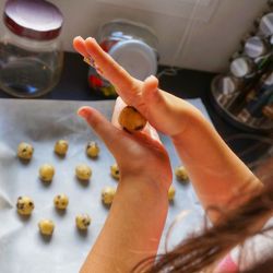 Cropped image of girl making cookies in kitchen