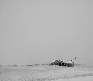 Barn on field against clear sky