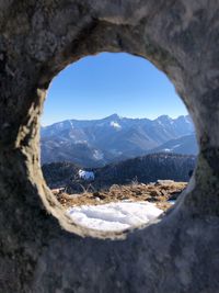 Scenic view of mountains seen through hole