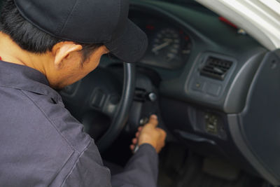 Rear view of man holding car
