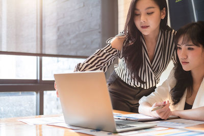 Businesswoman brainstorming while sitting at office