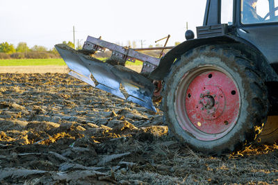 Close-up of abandoned truck on field against sky