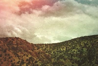 Scenic view of landscape against cloudy sky