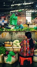 Rear view of woman working at market