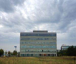 Low angle view of building against cloudy sky