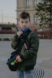 Portrait of boy standing on street