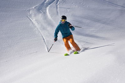 Full length of man skiing on snowy field