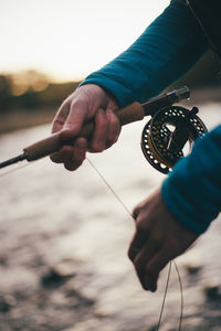 Close-up of hand holding fishing rod