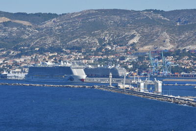 Scenic view of sea by city buildings