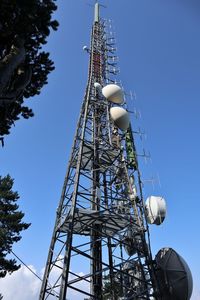 Low angle view of communications tower against sky