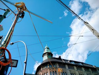 Low angle view of cables against blue sky