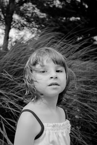 Portrait of cute girl against grass