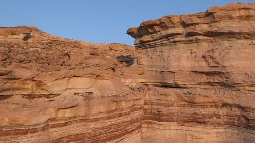 Low angle view of rock formations in desert against sky
