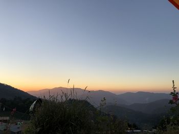 Scenic view of mountains against clear sky during sunset