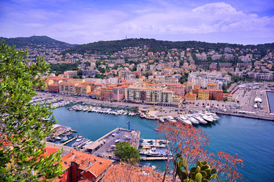 High angle view of townscape by river against sky